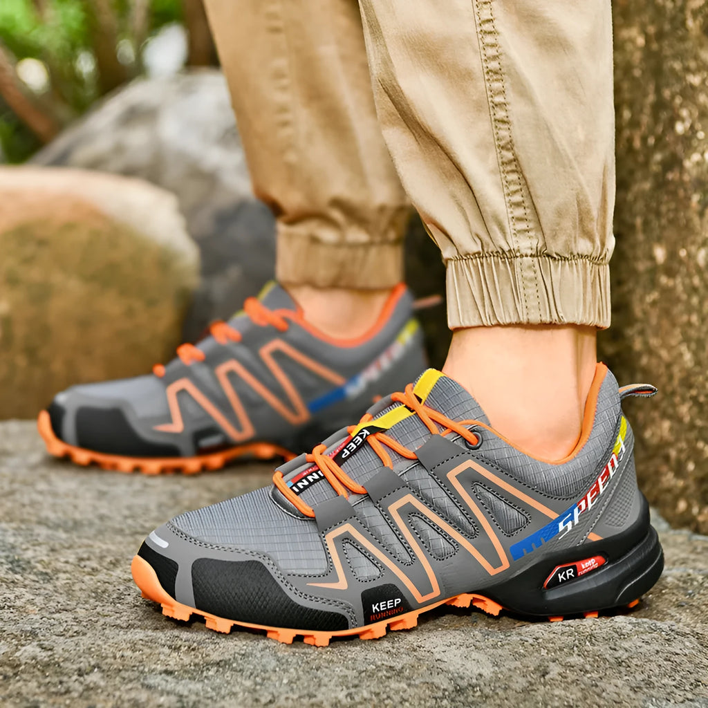 Men's plus size grey orange casual running shoes with low-top design and rubber sole.
