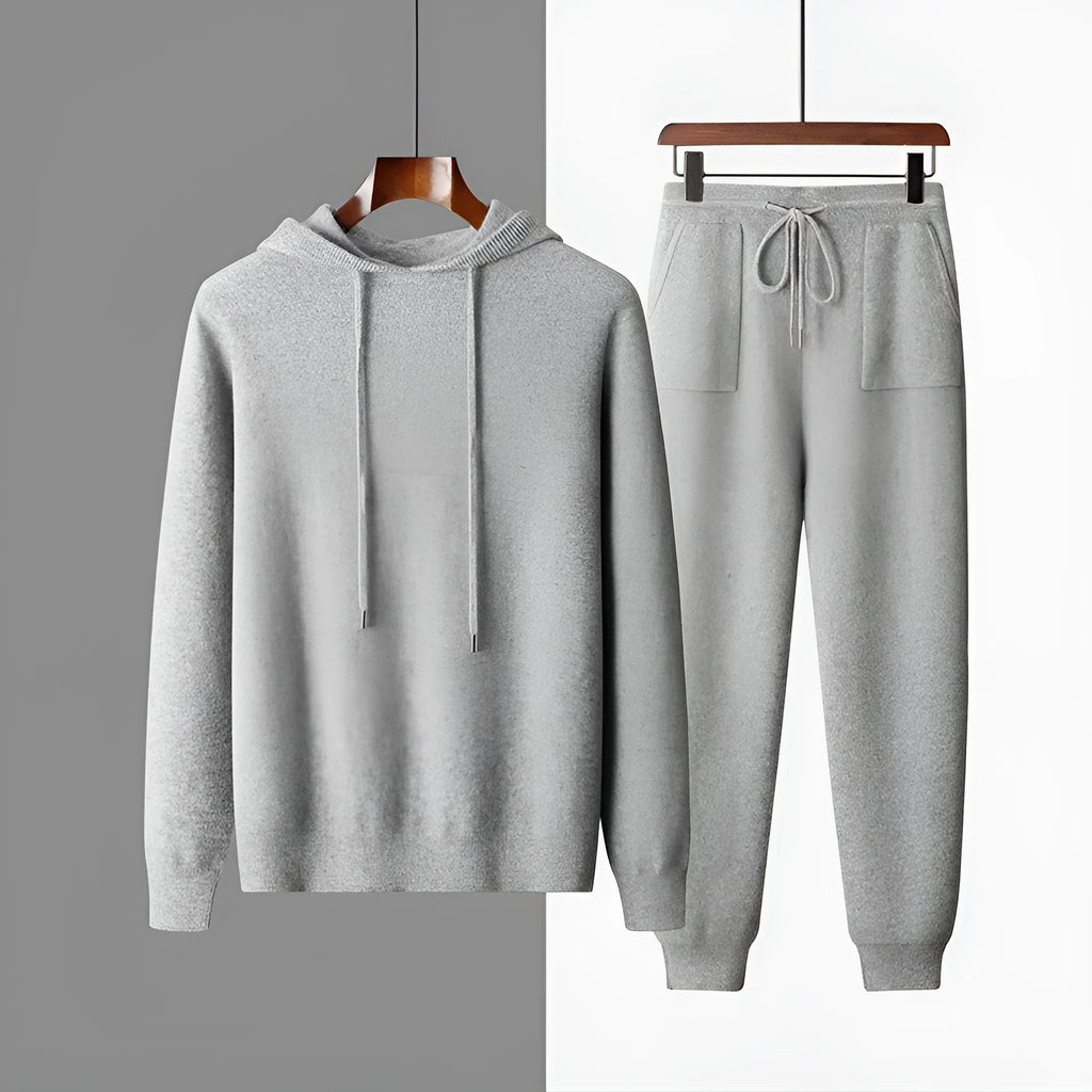 Men's light grey hooded cashmere sweatshirt and matching long pants laid flat as a complete casual winter set.
