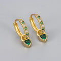 Women's gold-coloured heart drop earrings with a blue zircon stone centre and clip-on fastening.