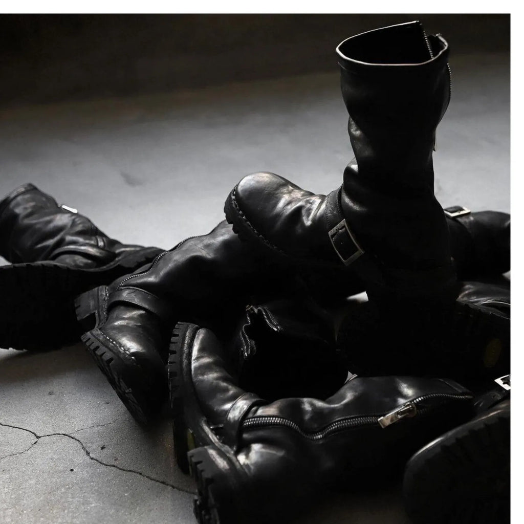 Men's black retro-style zip-up Martin boots with a round toe on a plain background.
