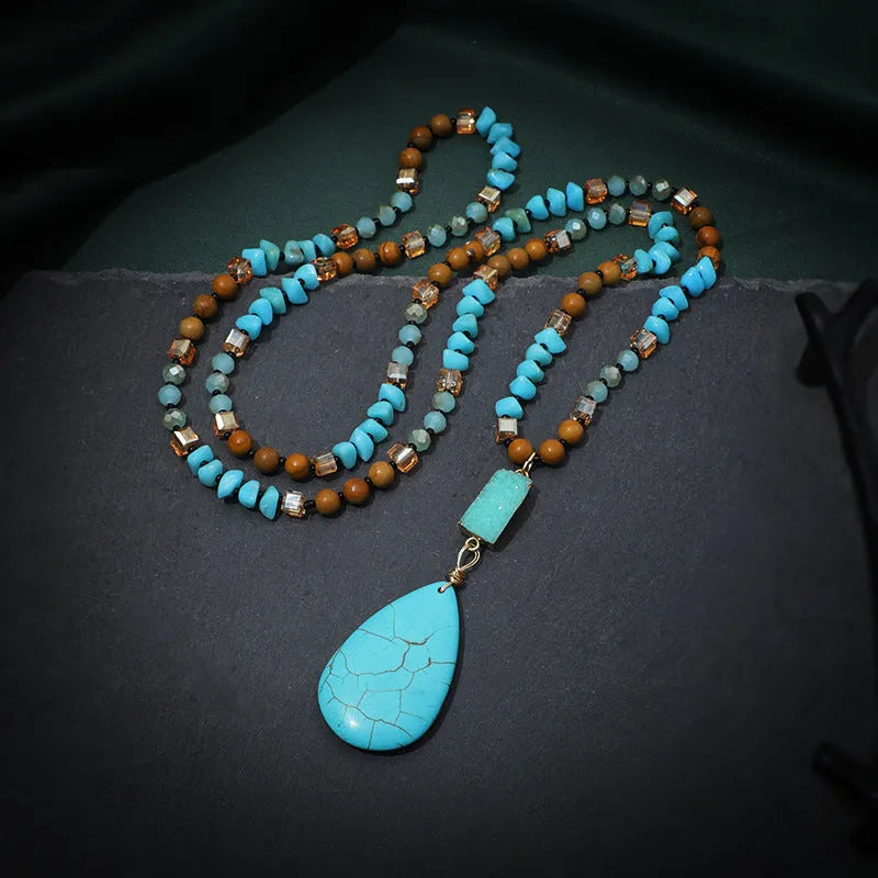 Long turquoise blue water drop pendant necklace with mixed gem inlay on a ball bead chain for women.
