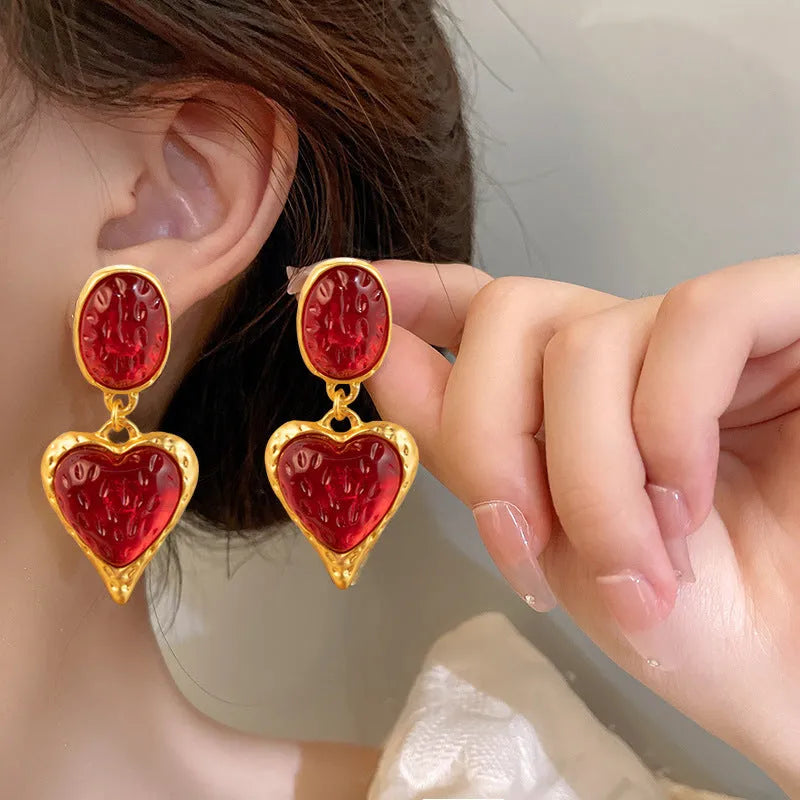 Four pairs of oval love heart stud earrings with silver needle pleated detailing in purple, red, green, and yellow-white colours