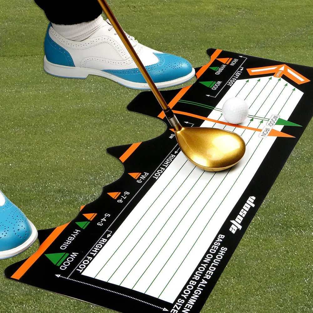 Black neoprene golf swing posture aid mat on grass, showing its compact size and alignment markings.