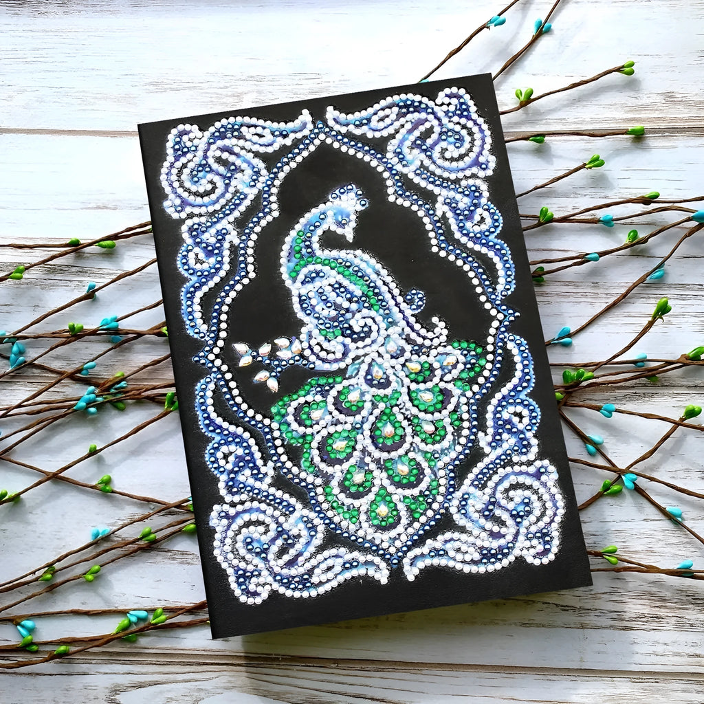 Black A5 diamond painting notebook with peacock design showing shaped and bright drill beads