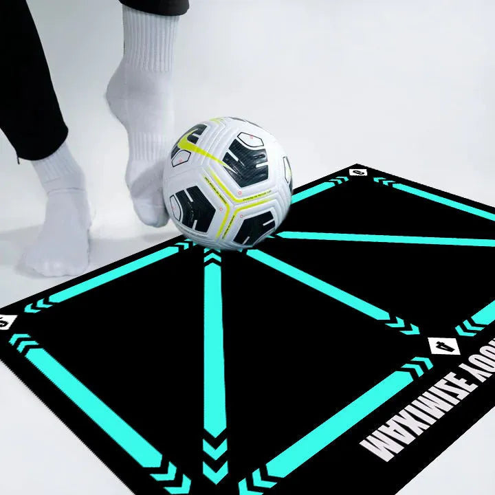 Large black rectangular rubber football training mat measuring 60x90 cm on a floor.