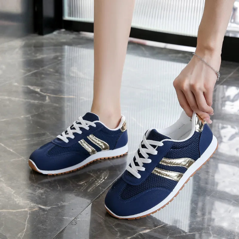 Blue women's casual tennis shoes with cross straps and a white rubber sole.