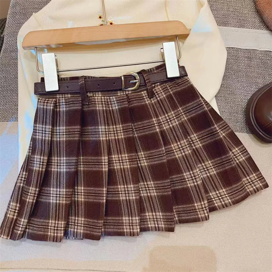 Girls' plaid pattern pleated A-line skirt in cotton blend fabric.