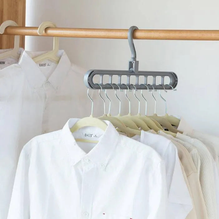 Pink or green heavy-duty plastic clothes hanger with rotating hook, shown holding a coat.