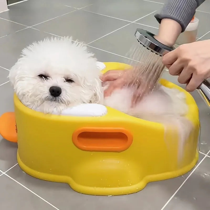 Duck-shaped blue PVC bathtub for washing dogs and cats on grass