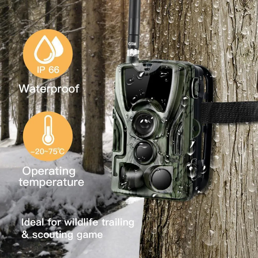 Green cellular trail game camera mounted on a tree trunk for remote deer and wildlife monitoring.