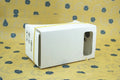 Pink and white cardboard VR glasses headset for smartphones with 3D lenses and adjustable strap