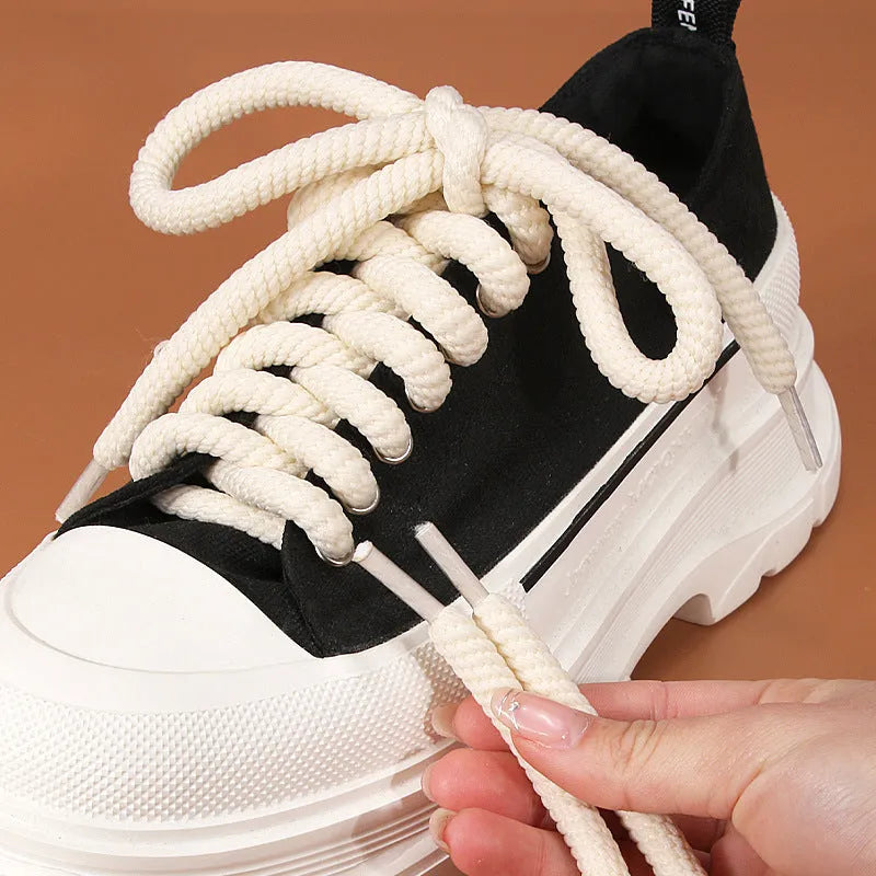 Round 10mm diameter woven shoelaces in white, beige and black colours showing thickness variations