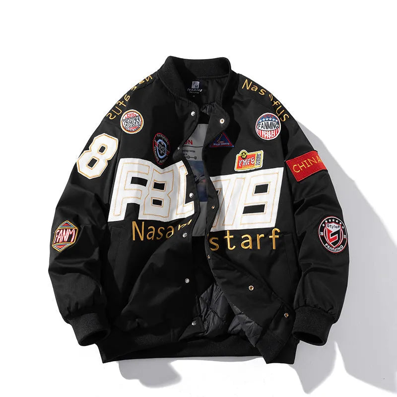 Man wearing a black motorcycle-style baseball jacket with a removable hood, featuring a side seam pocket.