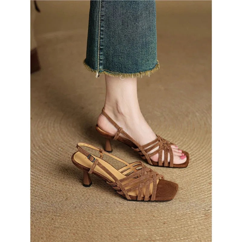 Retro beige high heel sandals with thin cross straps and an ankle buckle on a square toe.