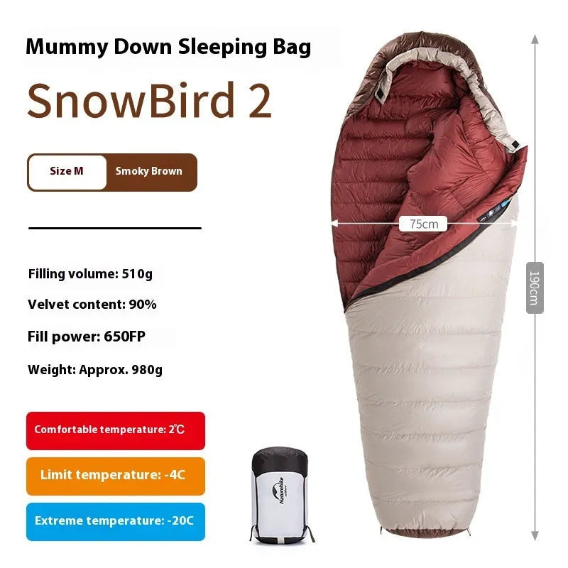 Mummy style goose down sleeping bag for adults shown with its storage bag