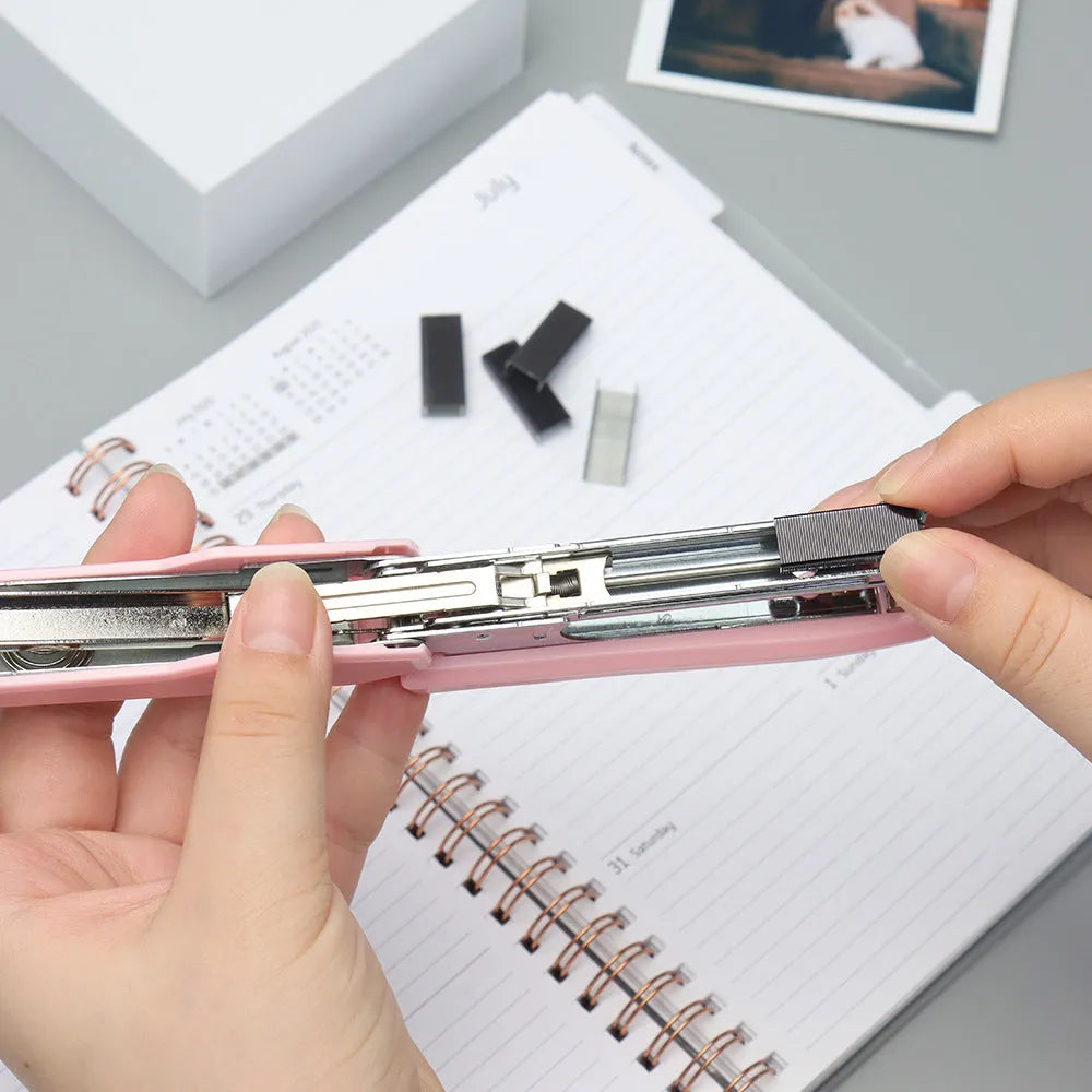 A box of 1000 metal office staples available in black, purple, rose gold, and rose red colours.