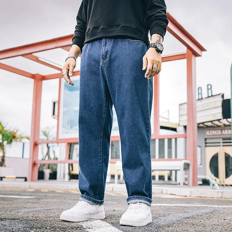 Men's loose straight-leg casual jeans in dark blue cotton fabric with a zip fly.