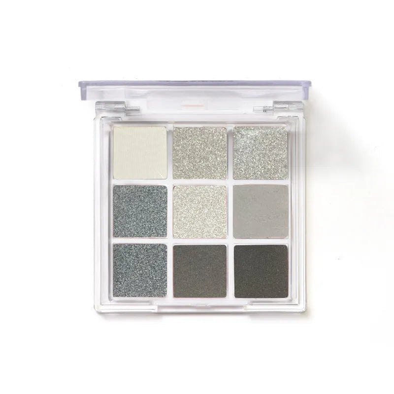 Nine-colour smoked eyeshadow palette showing white, silver, black and iron grey shades in compact case