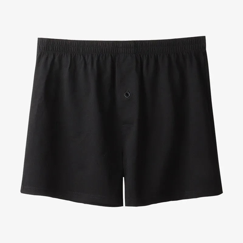 Men's solid colour cotton boxer shorts with a high waist and loose fit on a neutral background.