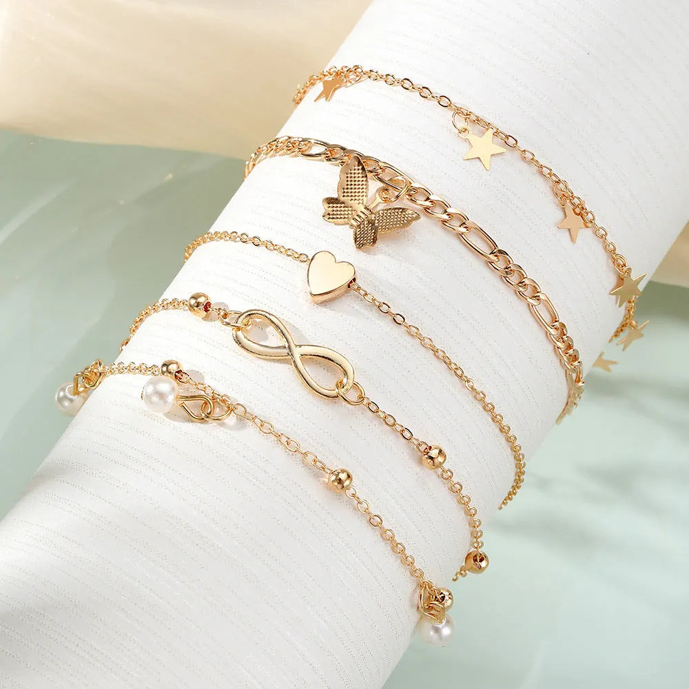 Women's 4-piece anklet set with butterfly, pearl and heart charms in alloy