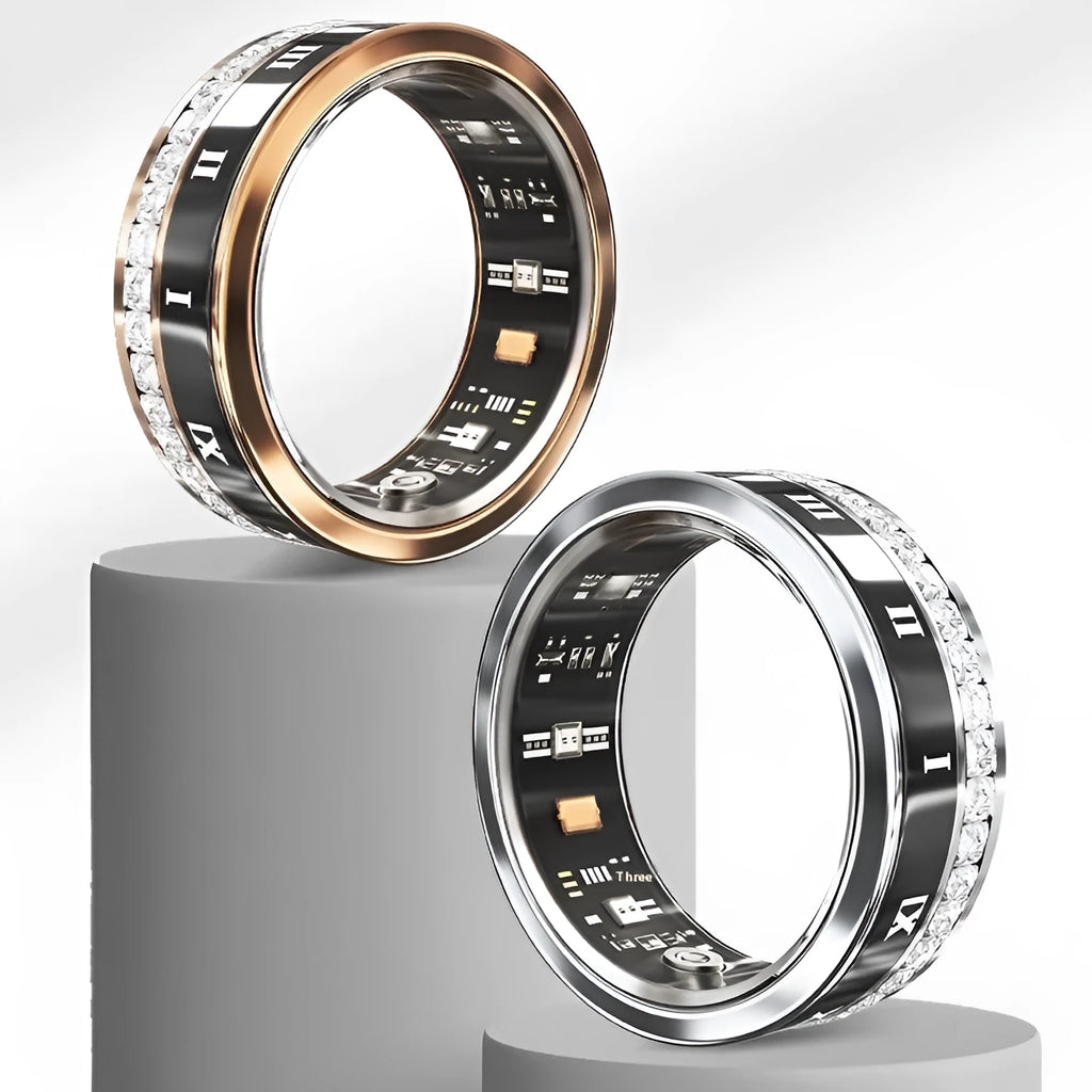 Silver and gold smart ring with diamond inlay on finger, showing charging cable and box.