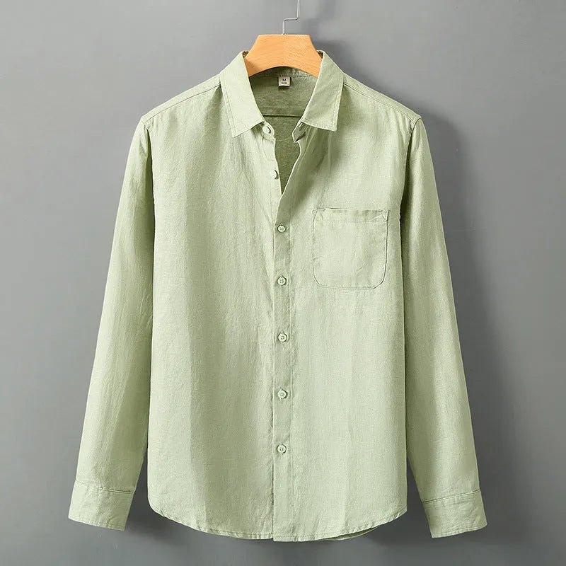 Linen long sleeve loose fit shirt in light green colour, shown on a hanger.