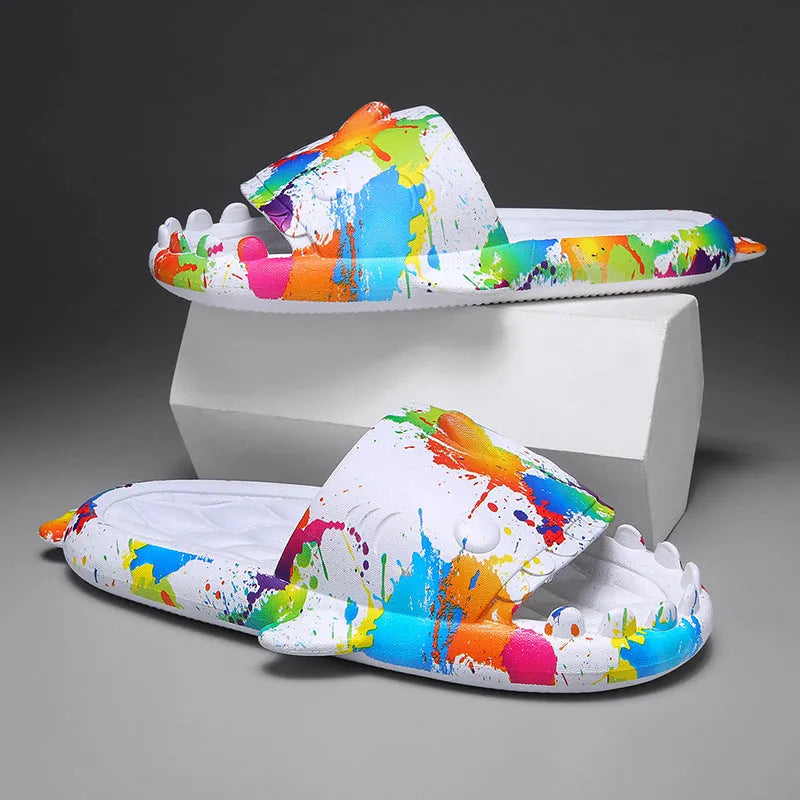 Pair of grey shark design open toe EVA home slippers on a white background.
