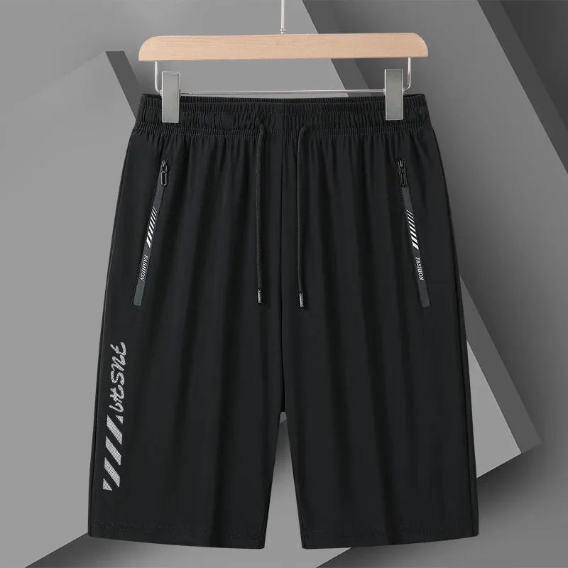 Men's black loose-fit nylon sports shorts with elastic waistband on a hanger