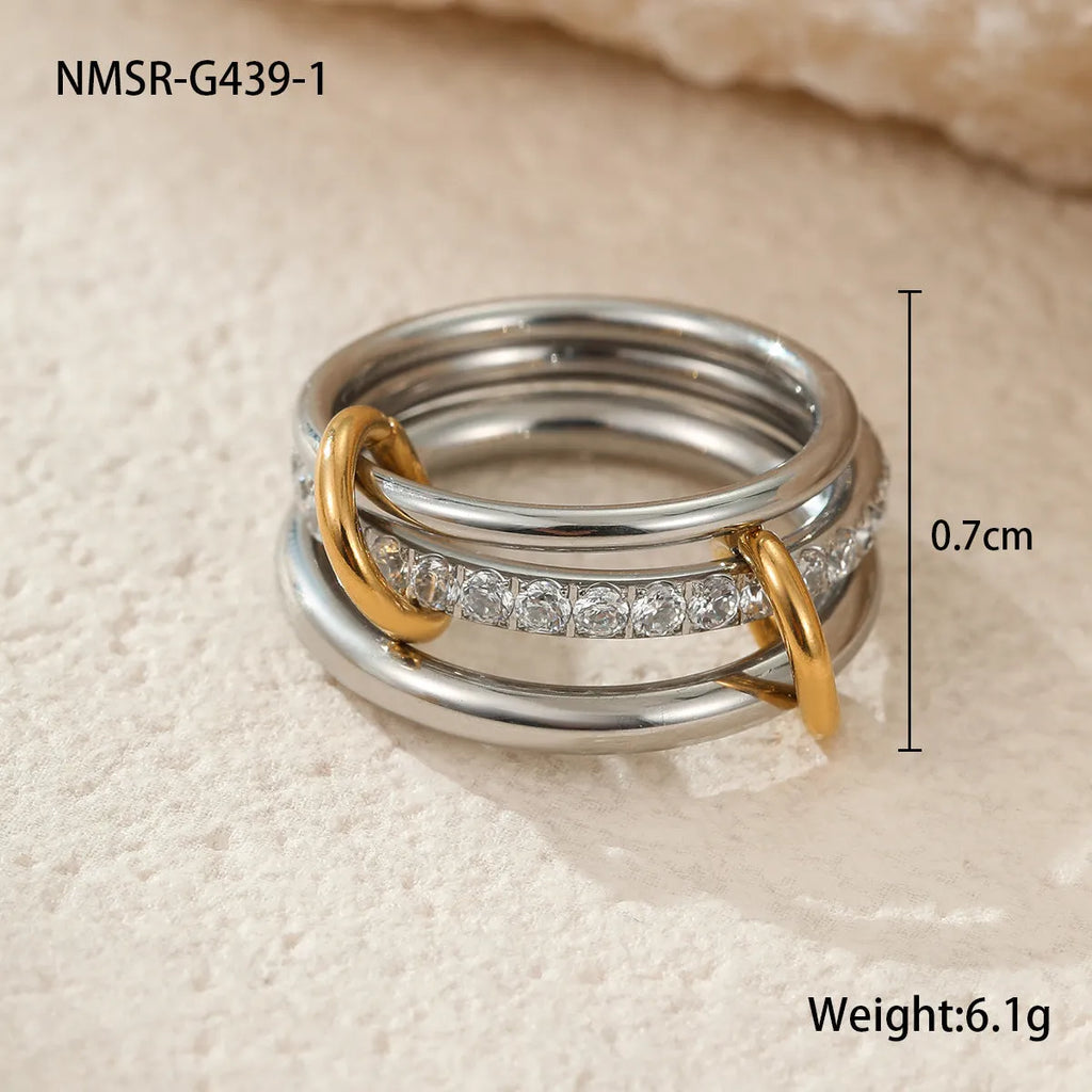 Stacked colour matching stainless steel rings with 18K gold electroplating in exaggerated jewellery styles