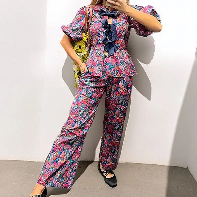 Women's floral print trousers suit set with tie-neck top and puff sleeves