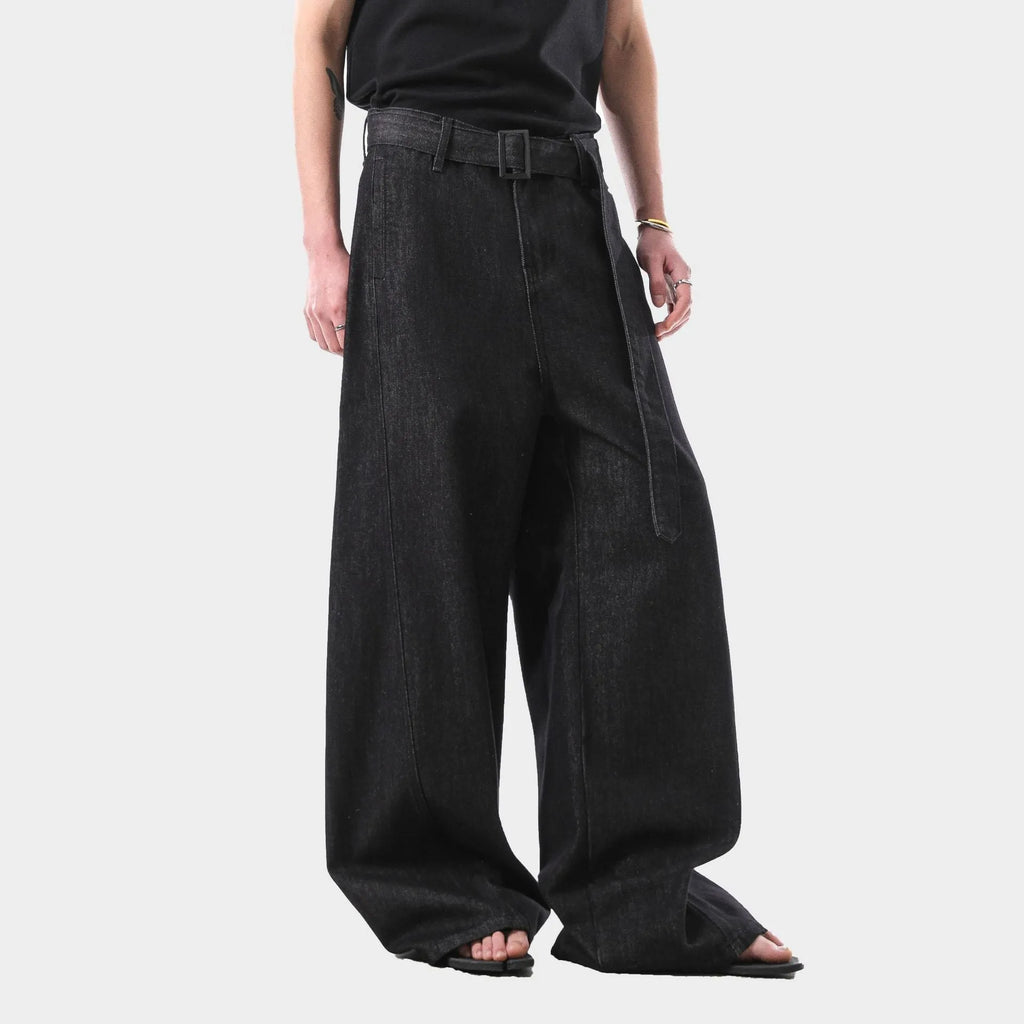 Black high-waist straight-leg jeans with gold details on a denim background.