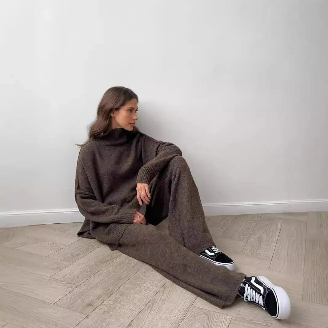 Women's dark grey acrylic jumper suit with side slits on the top and matching trousers.