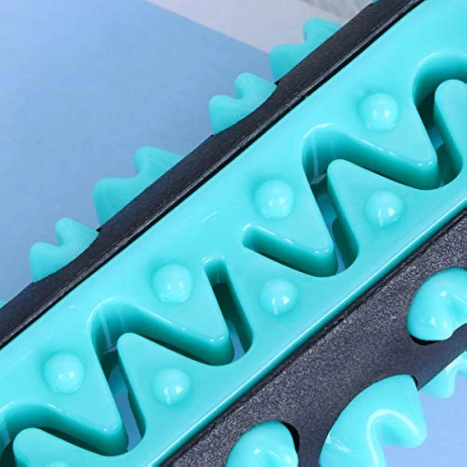 Natural rubber dog toothbrush chew toy in blue, showing textured surface for dental cleaning