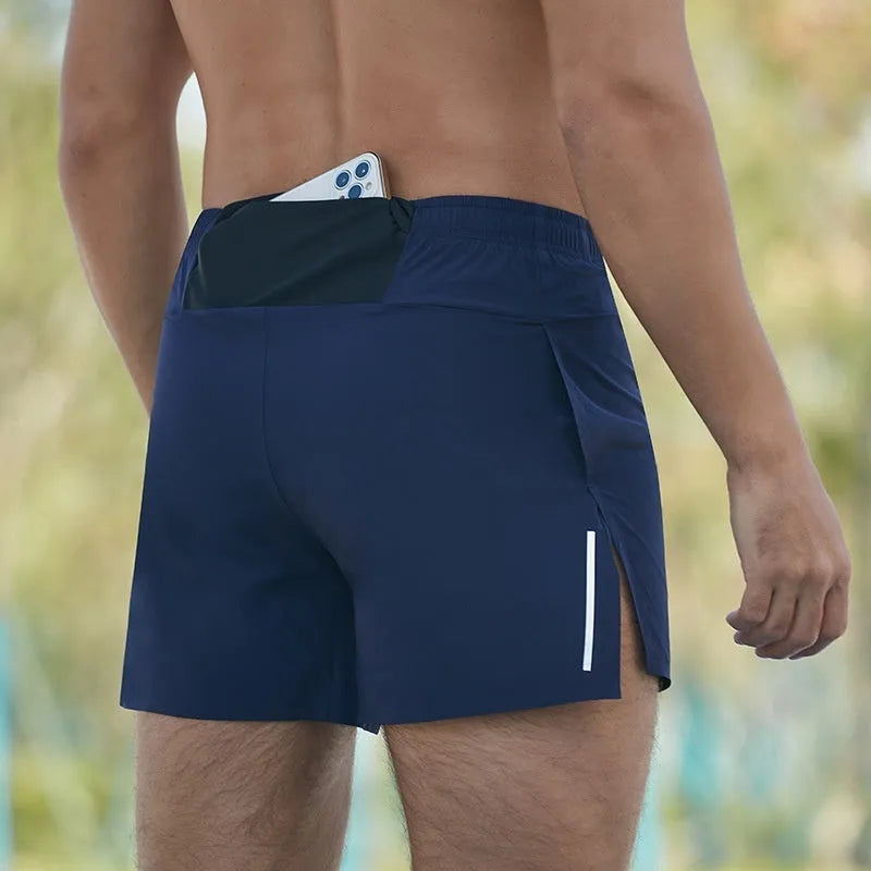 Men's red off-road running shorts with high waist and loose fit on a running trail.