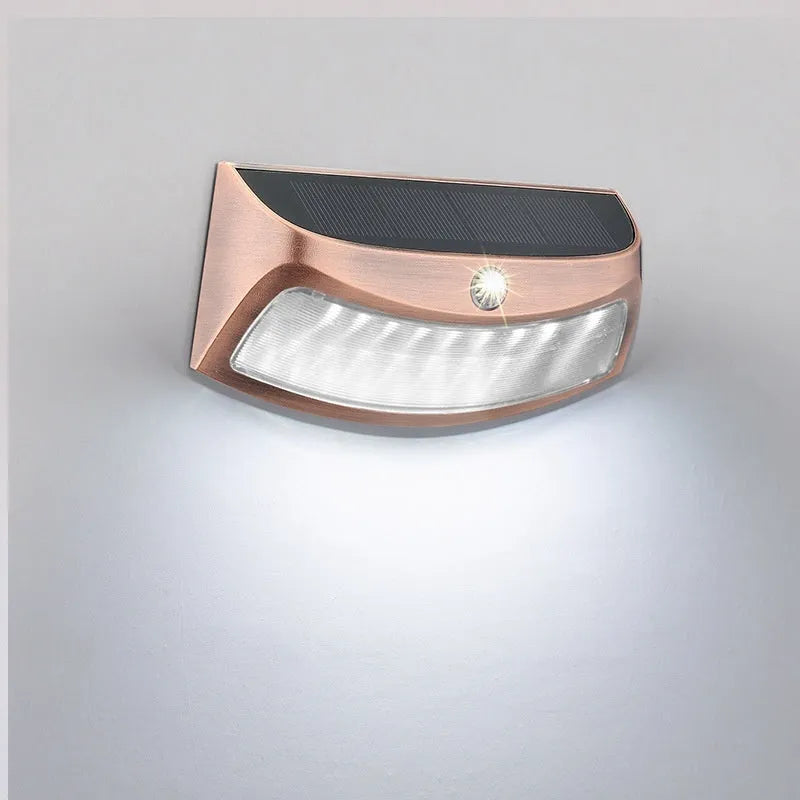 Solar outdoor wall lamp with smiling face design measuring 153mm by 76mm by 38mm