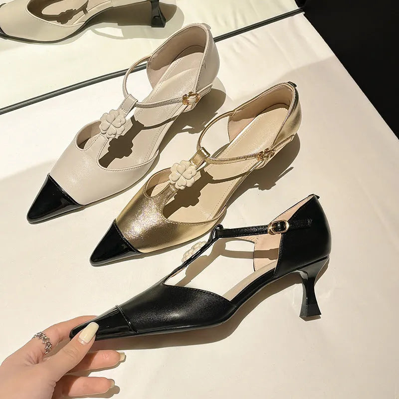Women's flower decorated stiletto heels with pointed toe and open mouth design in black, gold and white