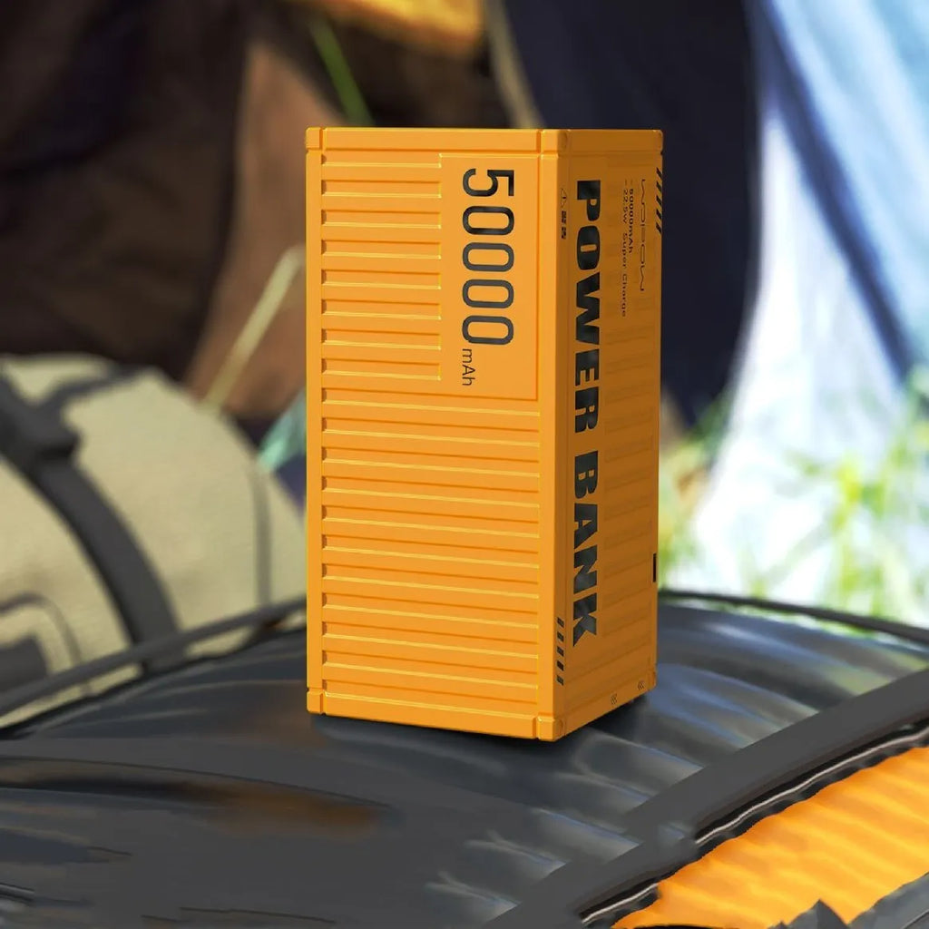 Yellow, black, and silver 50000mAh power bank with digital display showing battery level and five USB output ports.