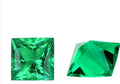 Loose cultivated emerald gemstone cabochon in Columbia green showing polished round and Asscher cut shapes.