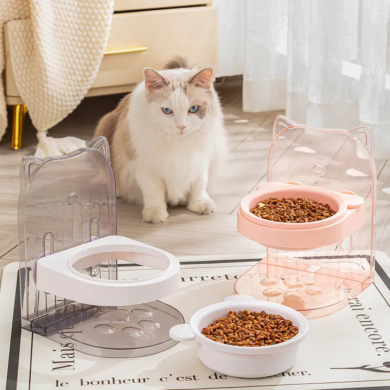 Grey adjustable height cat feeding bowl with cat ears and removable cage on a white background.