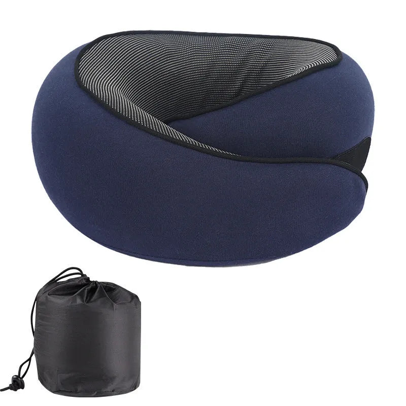A grey U-shaped memory foam travel neck pillow with a storage bag, shown on a plain background.