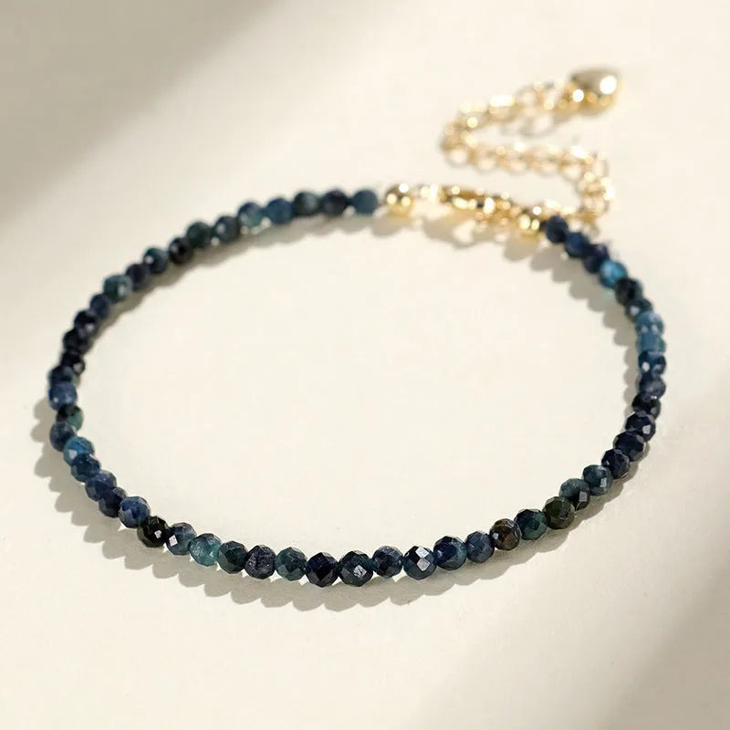 Blue tourmaline bracelet with 3mm cut beads and spacer bead design