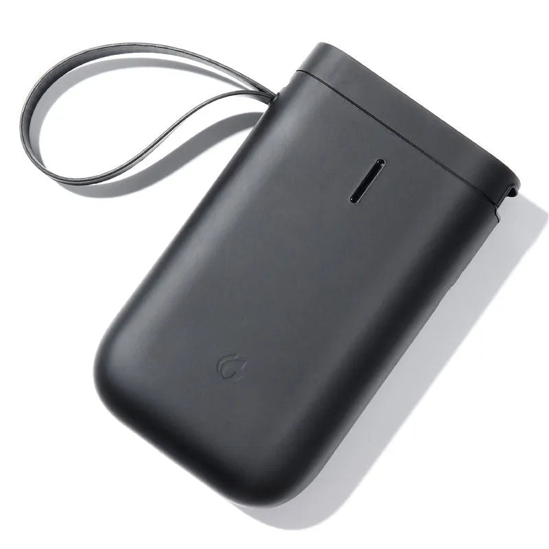 Compact D11 Bluetooth thermal label printer in black, with smartphone showing label design app.