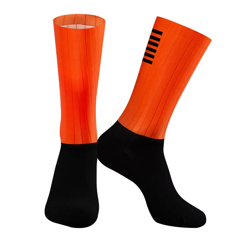 Cycling and running socks in orange colour with moisture-wicking athletic design