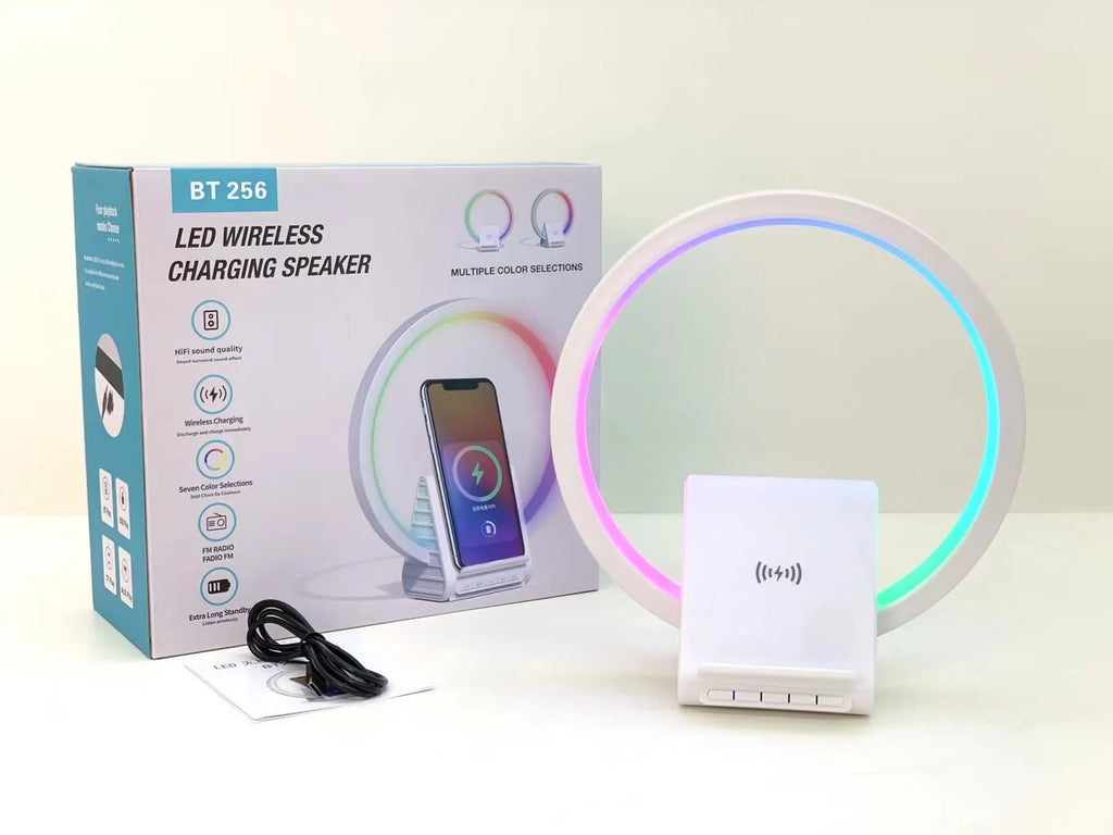 White smart Bluetooth speaker with integrated ambient lighting and a 15W wireless charging pad on top.