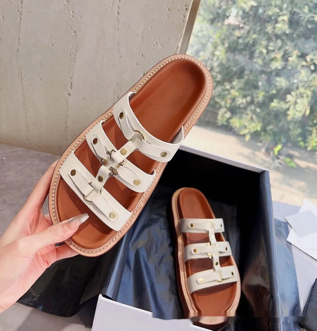 Women's brown patent leather Roman gladiator sandal slippers with crossed straps and sheepskin lining.