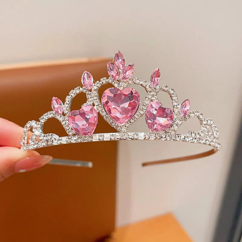 Close-up of a children's metal hairband headdress with a crown pattern in a light purple crystal colour.