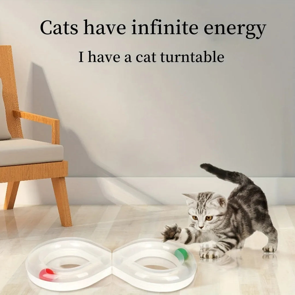 Blue and white cat turntable track ball toy with teasing stick attachment on flat surface