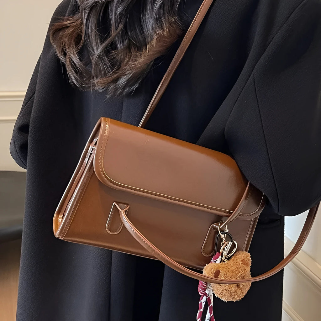 Women's brown PU Maillard shoulder bag with pendant detail, showing horizontal square shape and double straps.