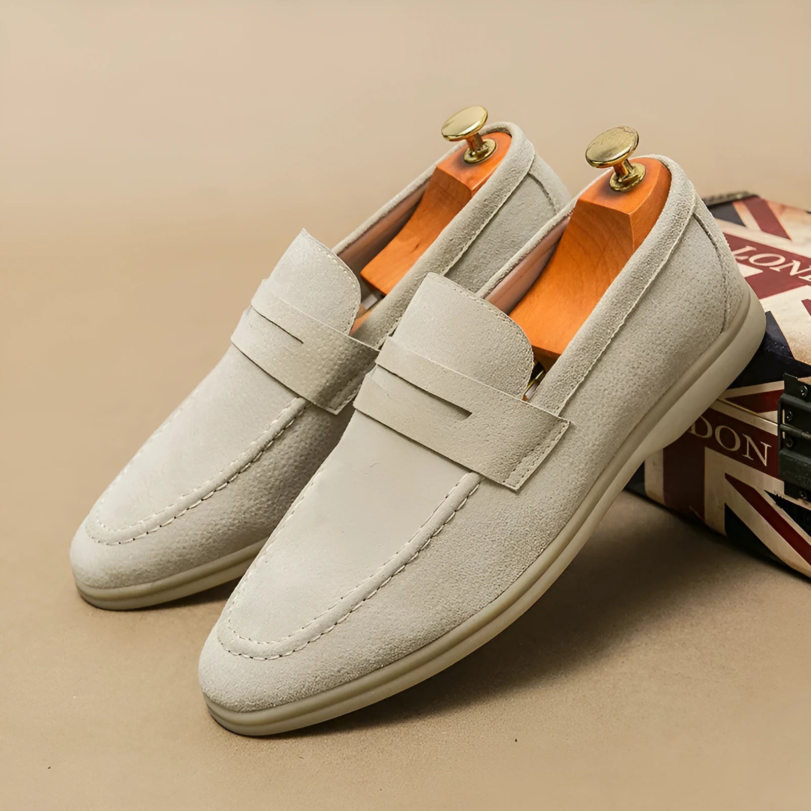 Men's leather slip-on casual shoes in beige with a rounded toe and rubber sole.