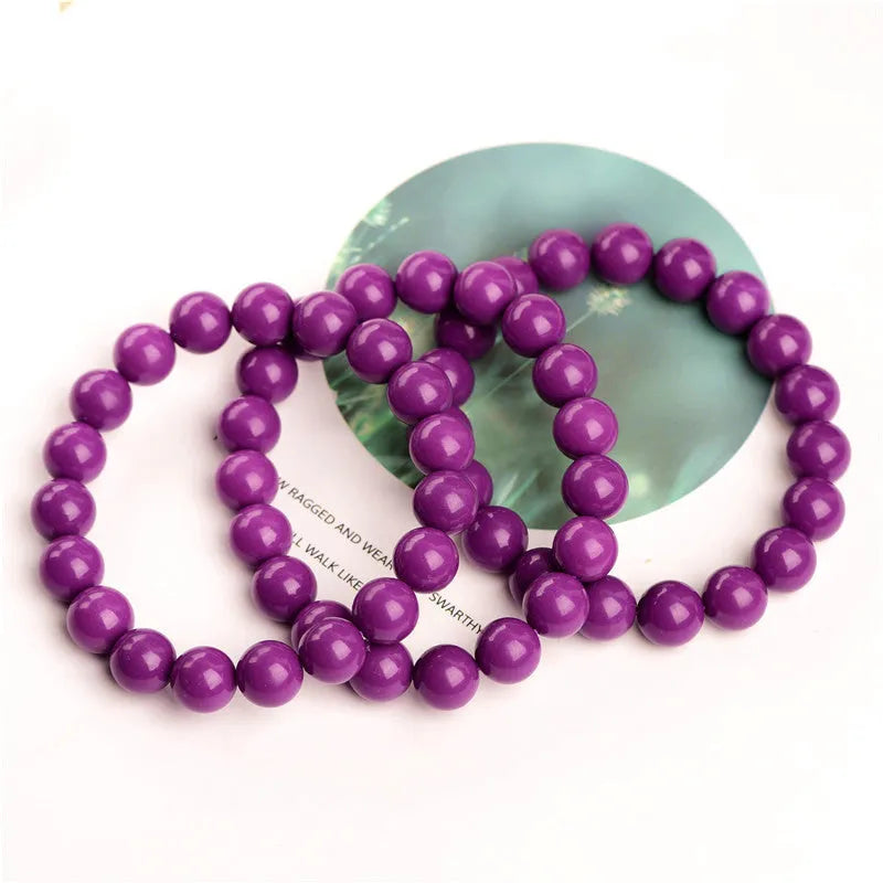 Purple Mica crystal bracelet with polished beads in a single circle design on a wrist.